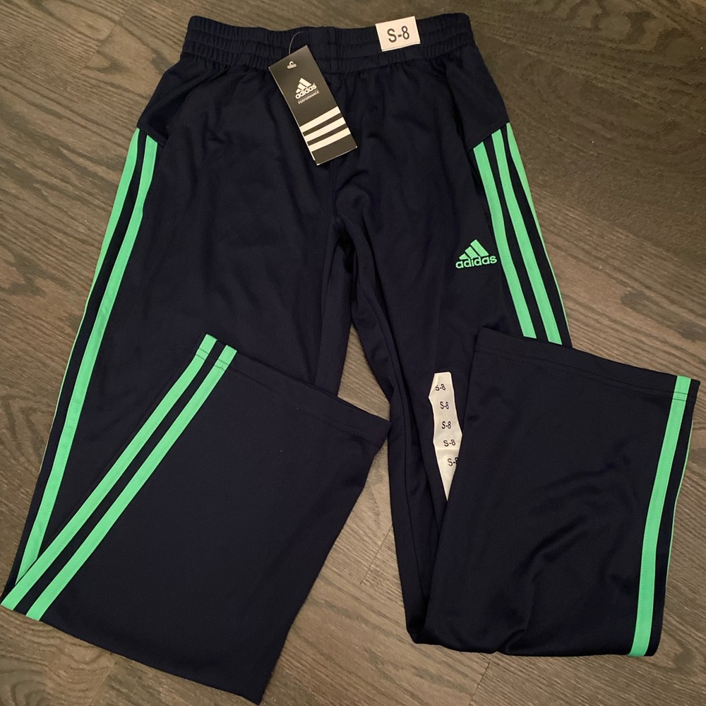 Brand new Adidas navy blue sweatpants with green stripes.